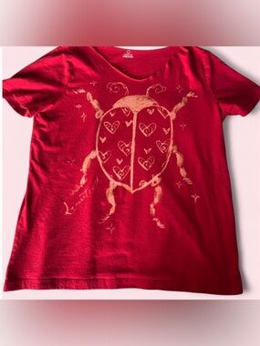 Women’s Red Graphic Tee with Gold Ladybug Design